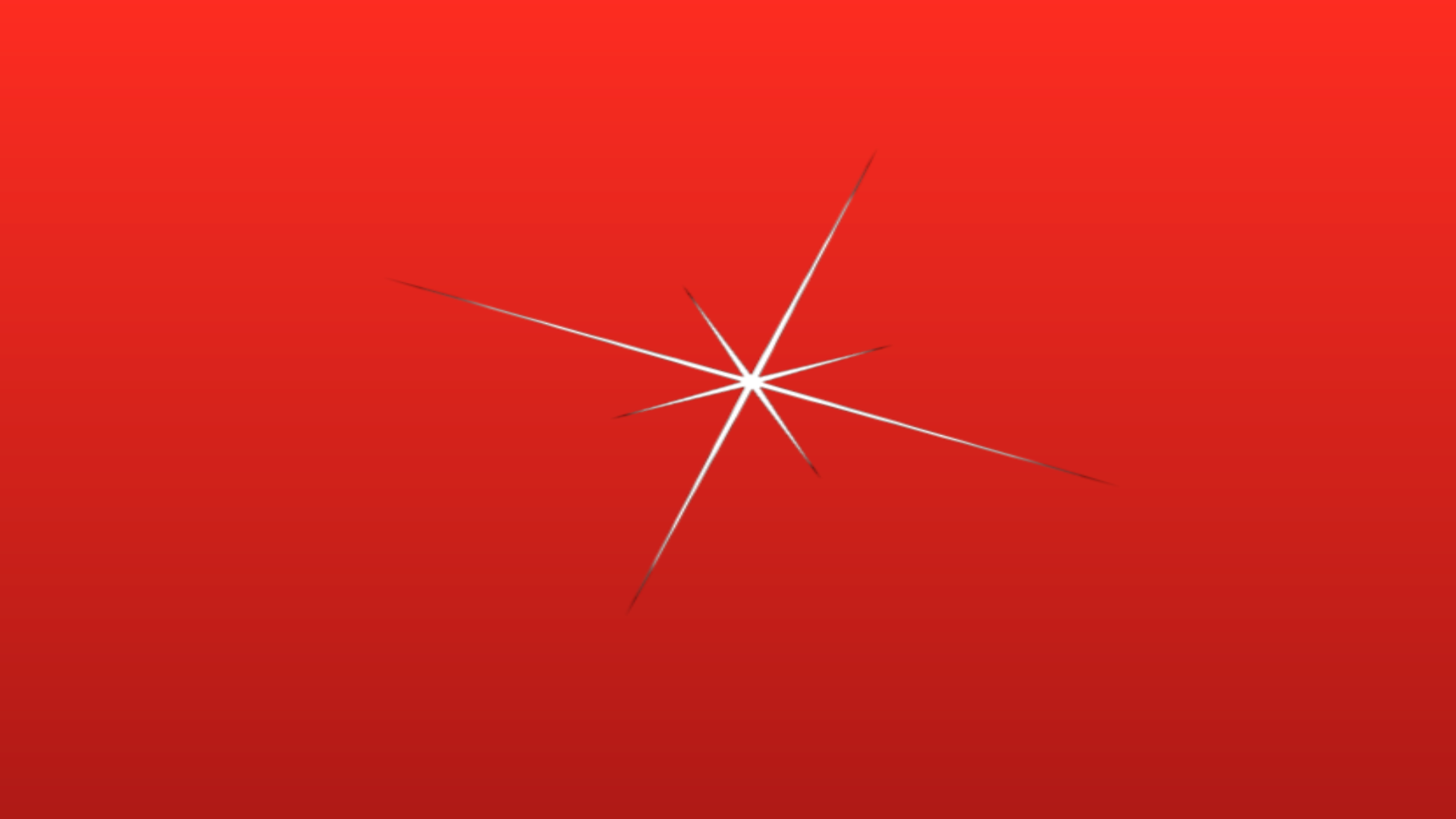 A red background with a starburst-shaped particle effect.